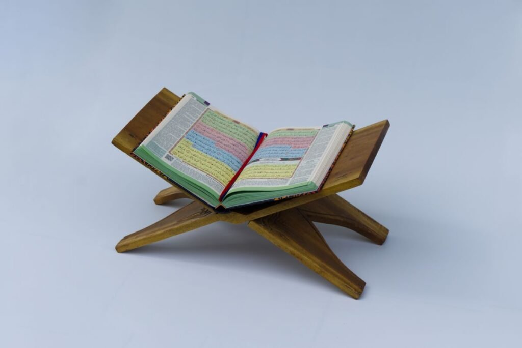 Colour-coded Quran open on a wooden stand for beginners