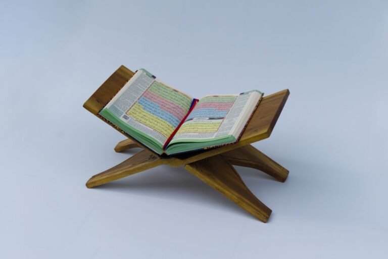 Colour-coded Quran open on a wooden stand for beginners