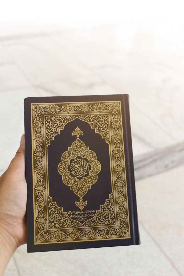 Hand holding the Holy Quran