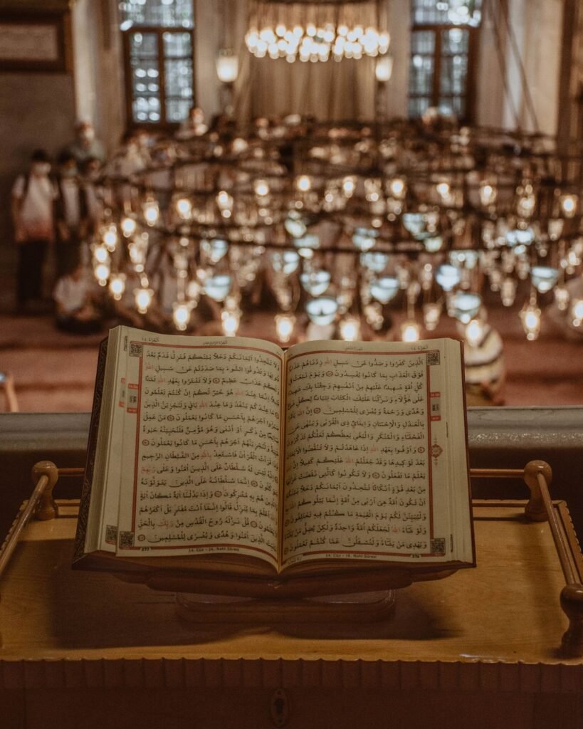 Open Quran with a mosque chandelier