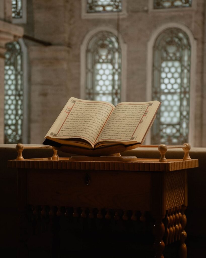 Open Quran on a wooden rehal stand in a mosque